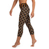 Left side view of black and gold sea slug capri leggings feature a continuous pattern from top to bottom of leggings.