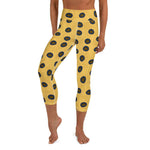 A person wearing Blue-Ringed Octopus capri yoga leggings, yellow background and brown spots outlined in dark blue.