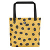 Yellow spotted tote bag with brown spots outlined in turquoise, Thalassas logo at top, inspired by the Blue-Ringed Octopus.