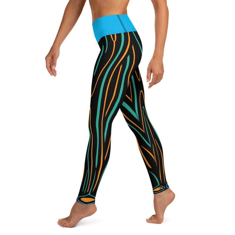 Left side view of model in Electric Swallowtail Sea Slug leggings with detail of pattern on left leg.