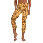 A person wearing capri length yellow spotted yoga leggings with a Flamingo Tongue Snail pattern.