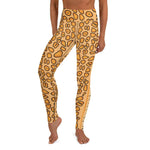 A person wearing full length yellow spotted yoga leggings with a Flamingo Tongue Snail pattern.