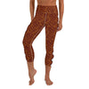 A person in capri yoga leggings, burnt orange, white scalloped design on the legs,  inspired by Glenie’s Chromodoris. 