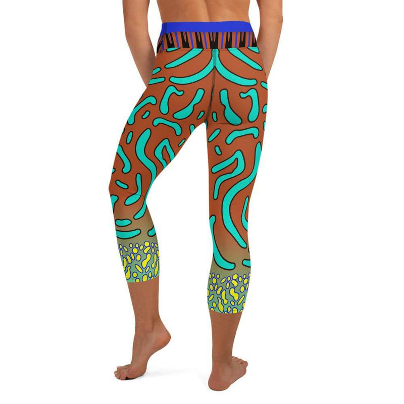 Back view of person in flattering fit capri yoga leggings with detailed mandarin fish design.