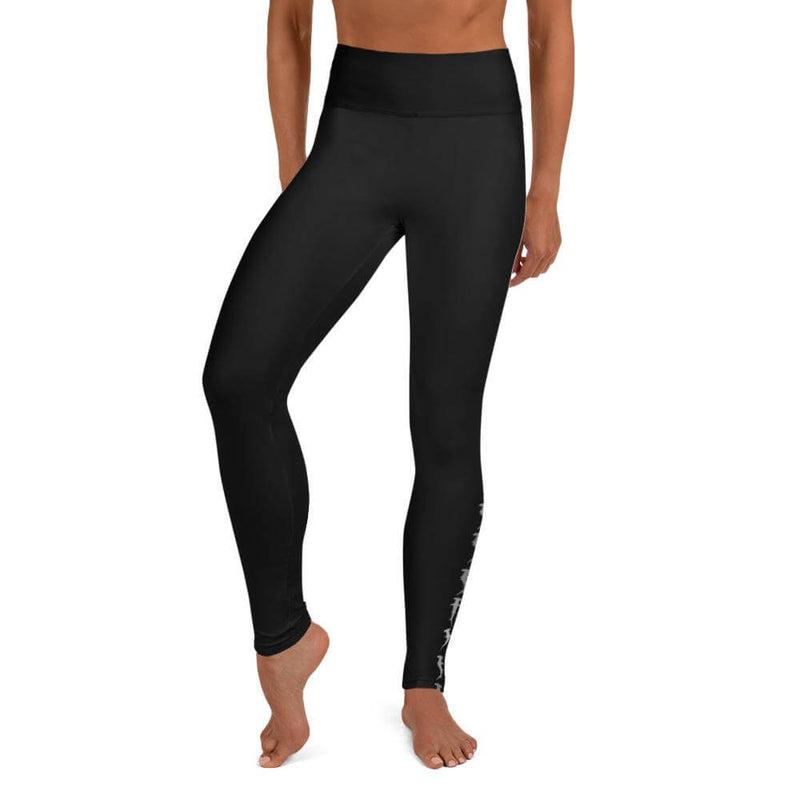 Front view of a woman in black hammerhead shark workout leggings. 
