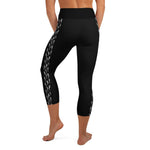 Back view of person in black capri yoga leggings showing left leg of hammerhead shark pattern.