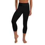 Front view of a woman in black hammerhead shark workout capri leggings. 