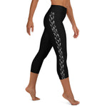 Right side view of a person in black athleisure hammerhead shark capri leggings.