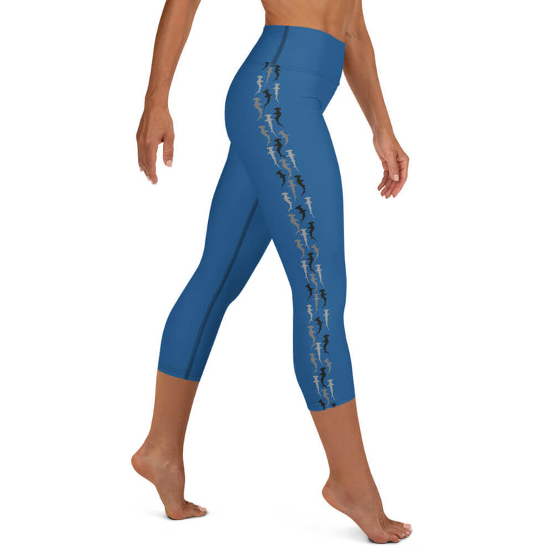 Right side view of a person in blue buttery-soft hammerhead shark capri leggings.