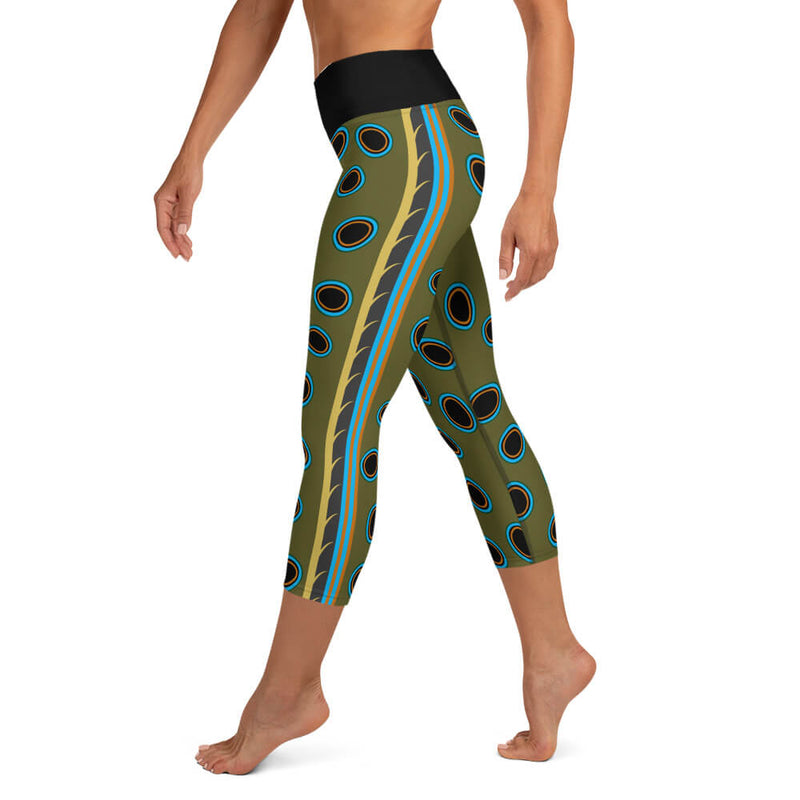 Left side view of Spotted Mandarin Fish capri leggings with multi-color stripes, yellow, dark grey, turquoise, orange on leg.