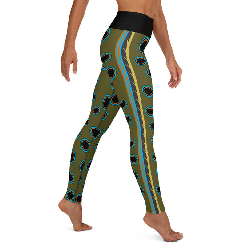 Right side view of model in Spotted Mandarin Fish of leggings.