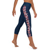 Right side view of a person wearing SM  size navy blue capri leggings with coral  stingray pattern on the left leg.
