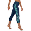 Right side view of person wearing M size navy blue capri leggings with turquoise stingray pattern on left leg.