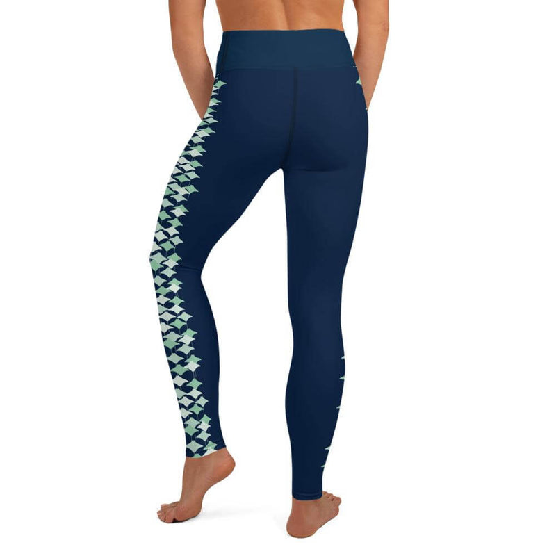 Back view of woman wearing traditional navy blue leggings with stingray pattern.