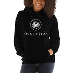 Person wearing a black unisex hoodie in color black, thalassas logo inspired by a greek coin, adult size 5XL.