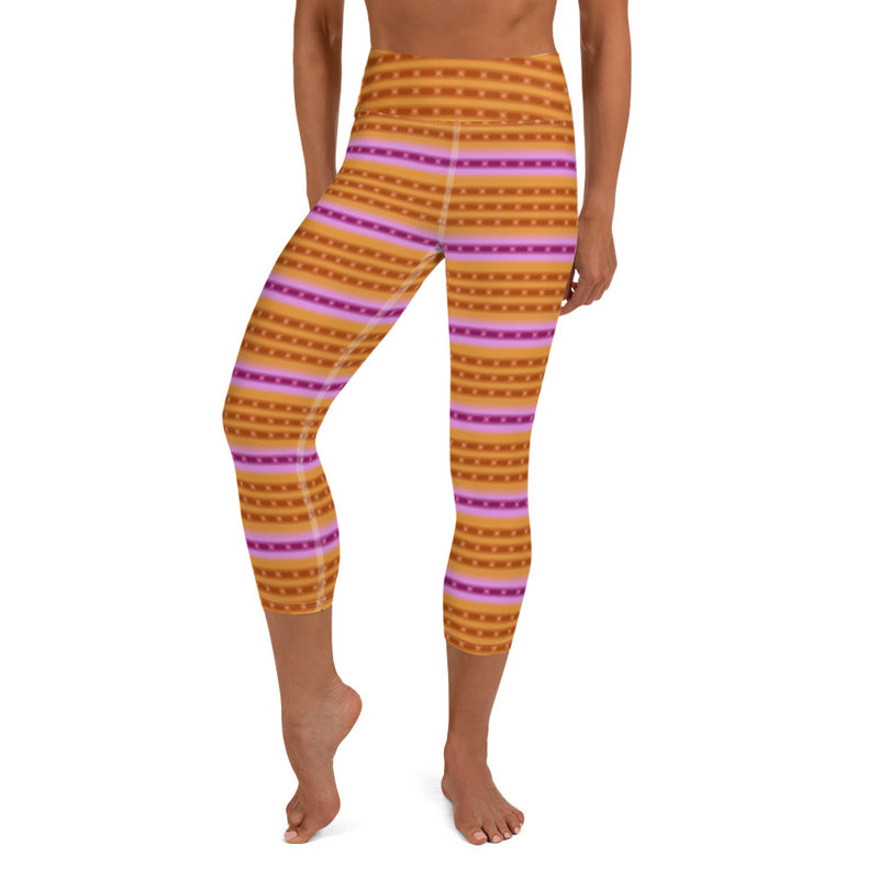 A person wearing orange capri yoga leggings in purple, pink, dark orange ringed design inspired by the Purple-Ringed Top snail.