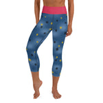 Person wearing blue capri yoga leggings with small black, yellow dots, pink waistband inspired by the painted infrucata sea slug.
