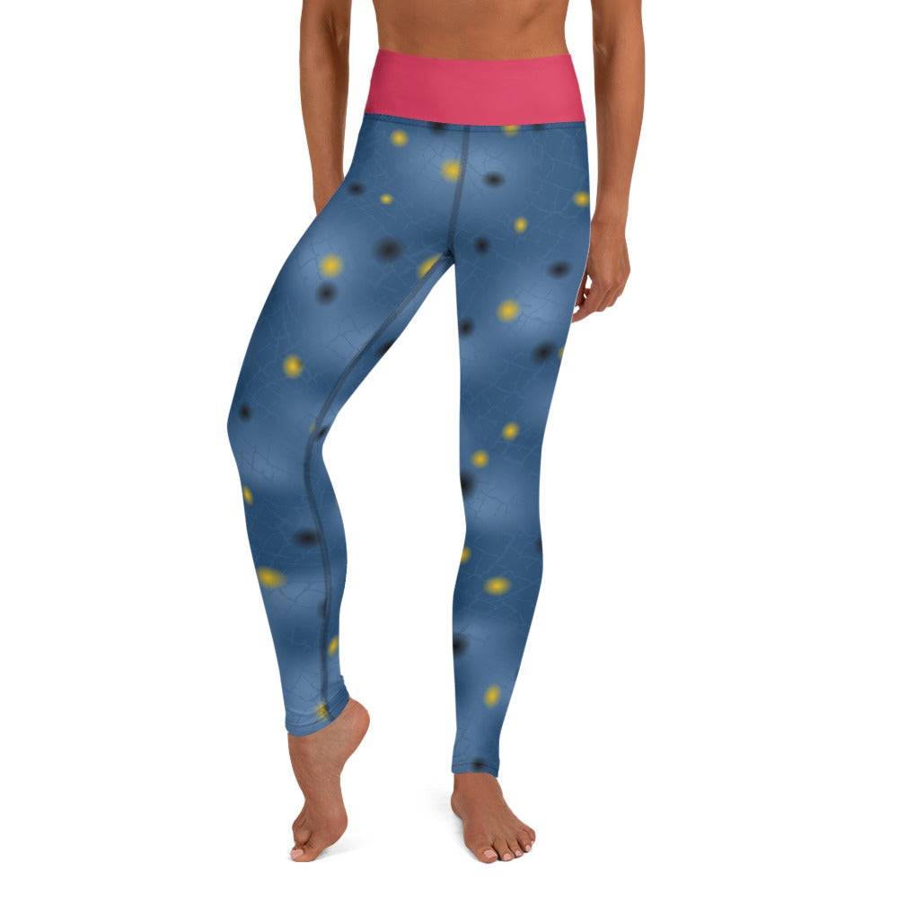 A person wearing blue yoga leggings, small black and yellow dots, pink waistband inspired by the painted infrucata sea slug.