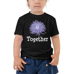 Toddler wearing a black short sleeve t-shirt with anemone design in size 2T. 