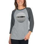 Person wearing ¾ sleeve raglan shirt with goblin shark design, heather charcoal sleeves, heather grey body, size L.